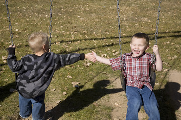 Boys playing on swing