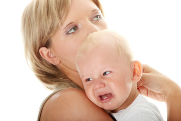 Mother holding her crying baby isolated