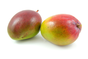 Two fresh mango fruit over white background