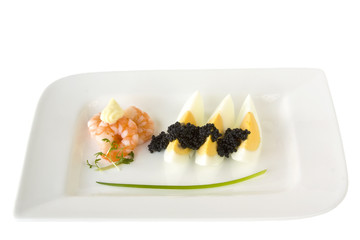 Ei mit Kaviar und Garnele auf weißem Teller