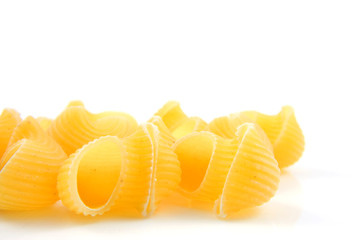 raw pasta noodles over white background