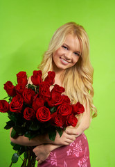 Beautiful young blonde girl with bouquet roses