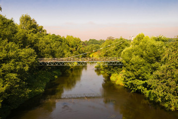 Fototapeta na wymiar Suspension bridge through the river
