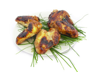 Barbecue from chicken hips decorated with salad