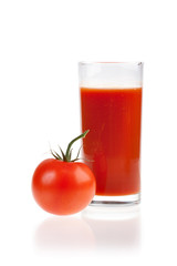 Ripe red tomatoes and glass of tomato juice.