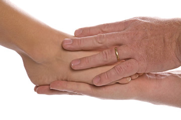 Fototapeta premium Womans foot in mans hands