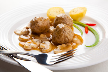 Roasted meatballs with mushrooms and boiled potatoes