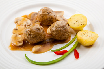 Roasted meatballs with mushrooms and boiled potatoes
