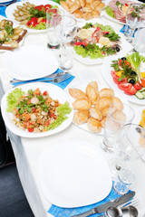 Table appointment with lots of appetizers and selective focus