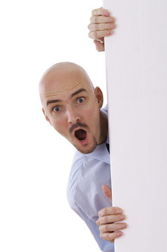 erstaunter mann schaut hinter leerer Wand hervor