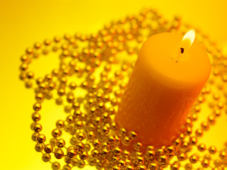 Holiday still life with candles on yellow background