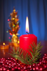 red candle on blue background