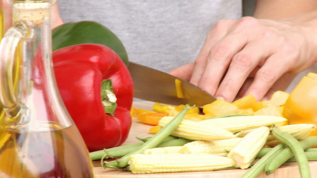 Hands cuttings vegetables with a knife