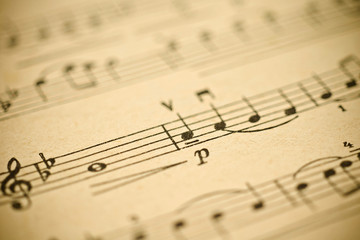 Obraz premium Classical music - notes on yellowed vintage paper sheet