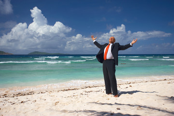 thankful businessman on sandy beach