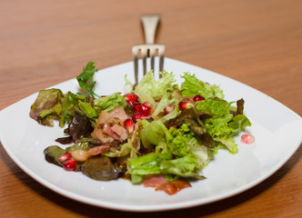 Warm salad with bacon and pomegranate