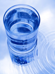 Glass of water in blue