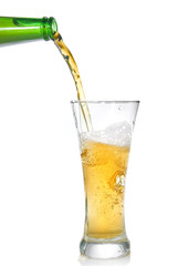 Beer pouring from bottle into glass isolated on white