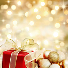 Christmas gift and baubles on defocused lights background - 18381890