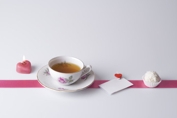 candle, cup of tea, love note and cookie