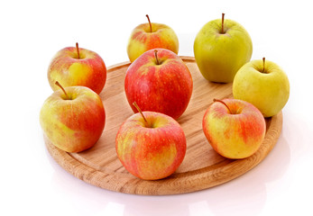 Few apples on wooden tray isolated on white