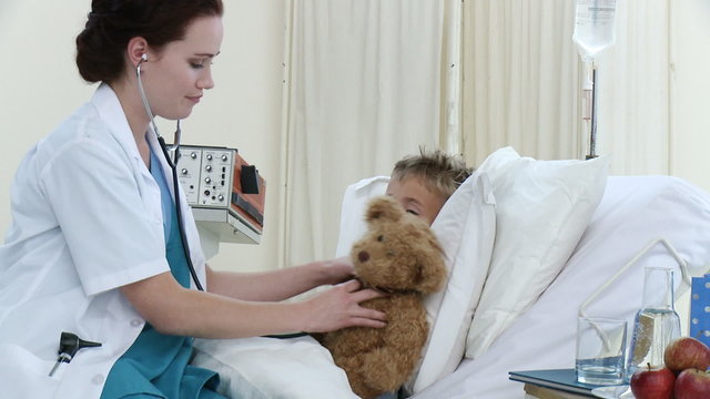 Female doctor examining a little patient