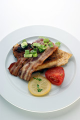 grilled carp fillet with organic vegetable on a plate