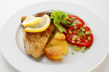 grilled carp fillet with organic vegetable on a plate