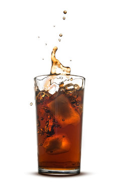 Beautiful splash of cola in glass isolated on white