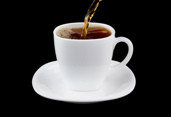 Pouring fresh tea to white cup isolated on black