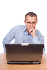 Young businessman working at laptop