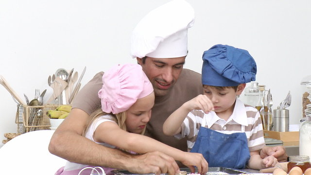 Father and children baking
