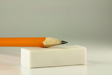 Pencil resting on a white eraser