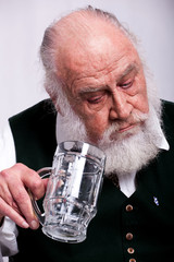 Bavarian man, looking surprised at his empty beer