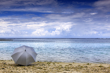 A silver-colored umbrella by the beach at Kandooma, Maldives