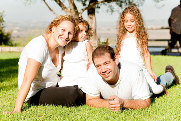 Parents and kids lying in the grass field
