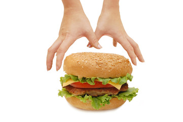 Hands reach for a hamburger isolated