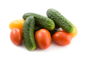 Cucumbers and tomatoes isolated on white