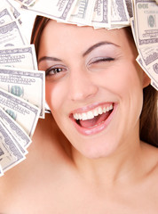 Attractive woman takes lot of 100 dollar bills