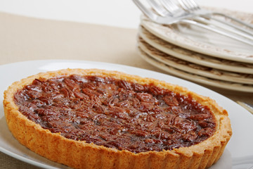 Fresh backed whole pecan pie ready to be cut and served