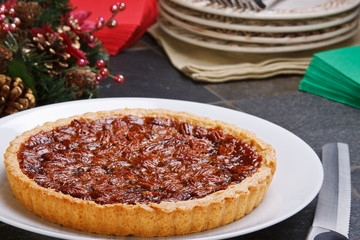 Fresh baked elicious pecan pie in a low key holiday setting