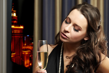 Beautiful lady with a champagne, night life style