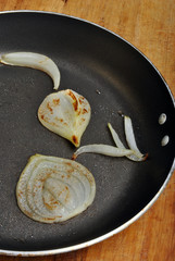 fried organic onion with oil in a pan