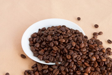 Fototapeta na wymiar Coffee beans in white plate
