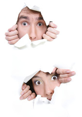 couple peeping through hole in white paper