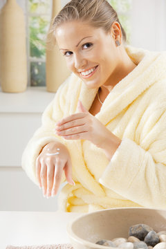 Woman using hand cream