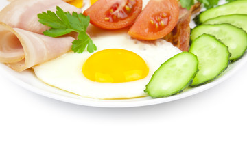 fried eggs with bacon and vegetables / on white background