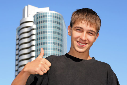 teenager with thumb up on the skyscraper background