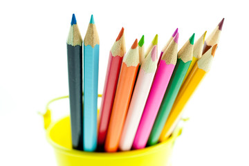 crayons in yellow bucket