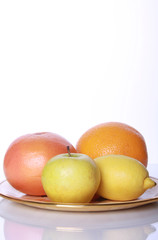 Fresh useful fruits on mirror table
